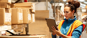  Woman Consulting Electronic Device in Warehouse