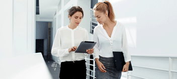 Two business women looking at tablet