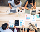 Overhead view of business person at  table looking at charts