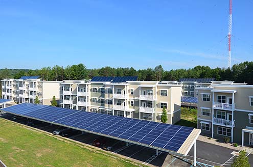 NetZero Village - solar panels next to housing unites 