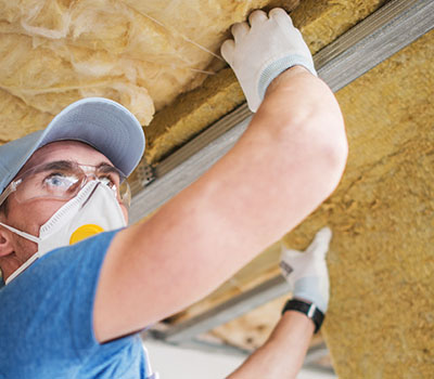 Worker installing insulation.