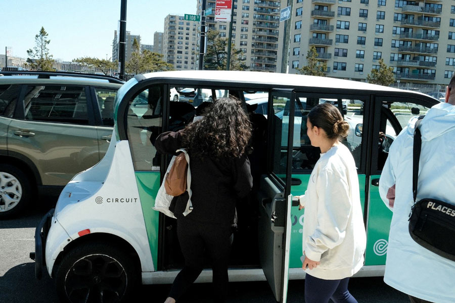 Riders boarding a Circuit GEM car at an Earthday 2025 event 