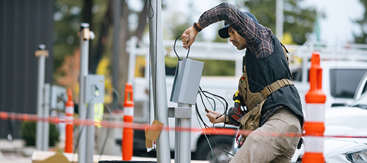 worker setting up ev charging station