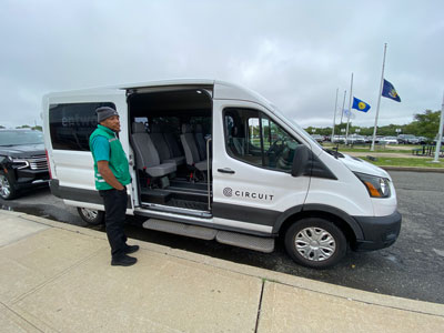 A Circuit van and driver showing the inside of a Rockaway Rides passenger van. 