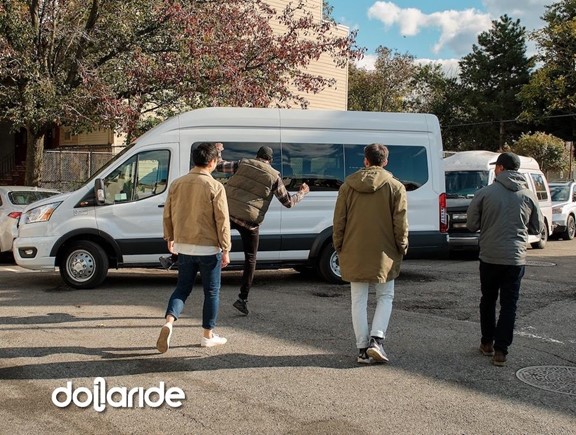 People walking toward a Dollaride van