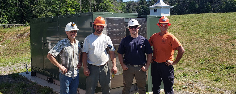 Four people in hard hats posing for a photo.