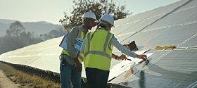 Technicians working on a solar panel