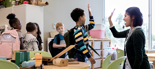 teacher giving student high five