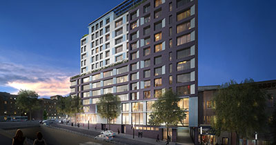 Rendering of one side of 2050 Grand Concourse building lit from within, surrounded by dark blue night sky.