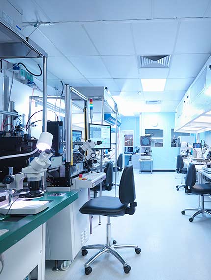 Medical lab with rolling chairs and equipment setup at work stations.