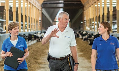 Jessica, Bob, and Crystal walking through barn and talking.