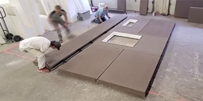 People assembling a prefabricated wall.