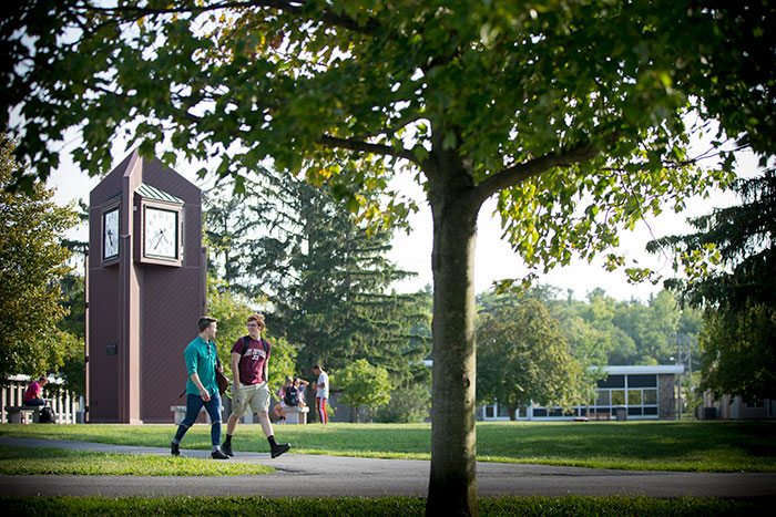 Studerende går på Jefferson Community College campus med klokketårn i baggrunden.