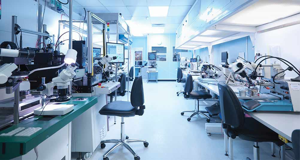 Medical lab with rolling chairs and equipment setup at work stations.