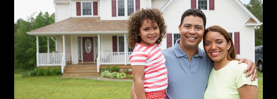 family in front of a home