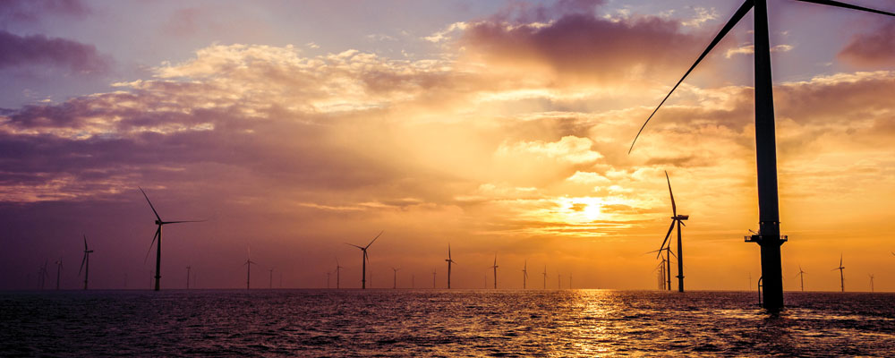 Offshore wind turbines at sunset