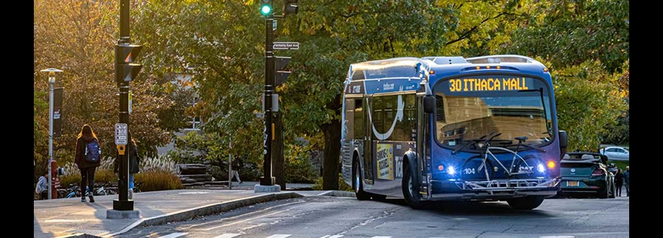 City bus turning a corner on a street with "30 Ithaca Mall" digital sign displayed on front.