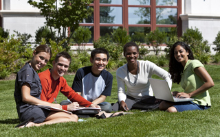 Five students sitting outside